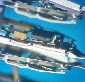 Closeup of hard drive heads and sliders under magnification